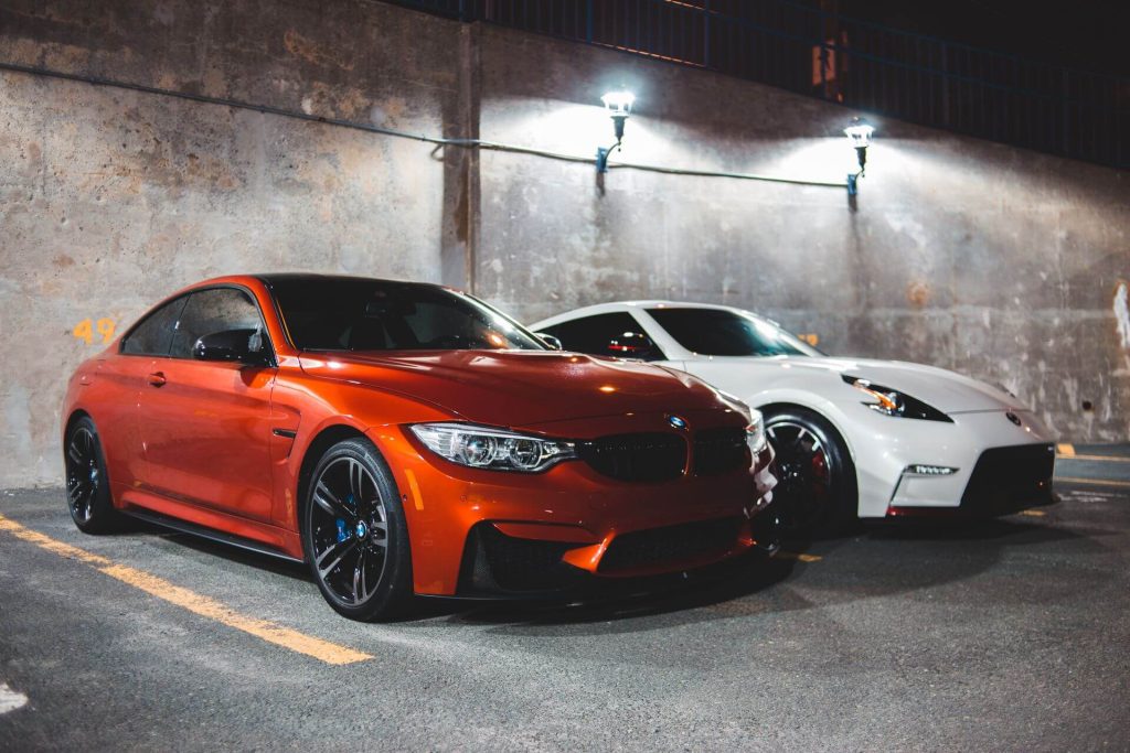 orange bmw and white nissan